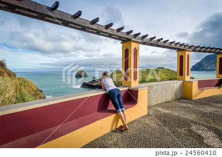 Woman looking at the ocean from special viewpoint Woman looking at the ocean from special viewpoint 24560410