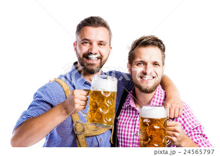 Men in traditional bavarian clothes holding mugs Men in traditional bavarian clothes holding mugs 24565797