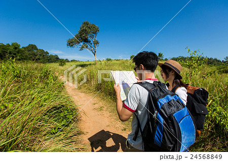 Couple tourists opening the map tourist Couple tourists opening the map tourist 24568849