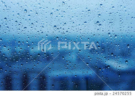 Water Drops on Glass with Blurred Cityscape View 24570255