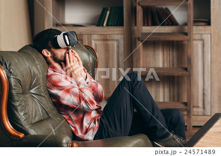 Excited man watching video in vr glasses 24571489