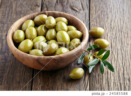 Green olives on a wooden background Green olives on a wooden background 24585588
