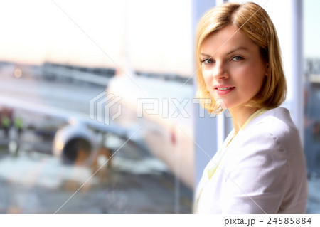 Woman standing near window. Airplane background 24585884