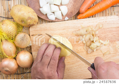 Chef cutting Potato with knife Chef cutting Potato with knife 24587636