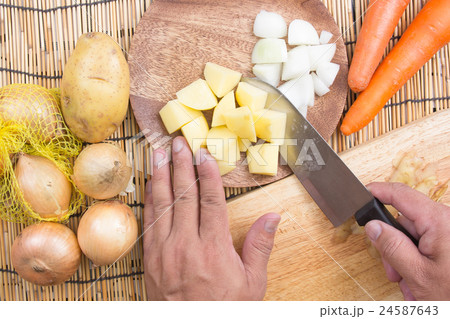 Chef cutting Potato with knife Chef cutting Potato with knife 24587643