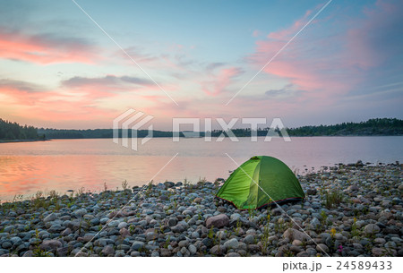 Beautiful sunset view on the calm lake and small Beautiful sunset view on the calm lake and small 24589433