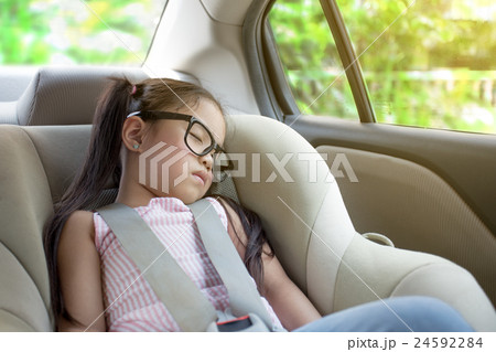 little girl sleeping in the cars eat 24592284