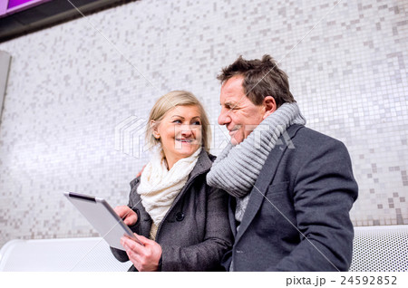 Senior couple sitting at the underground platform Senior couple sitting at the underground platform 24592852