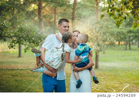 Happy young family on a background of water in the Happy young family on a background of water in the 24594289