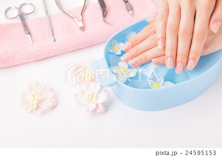 Beautiful woman's hands with manicure in bowl of 24595153