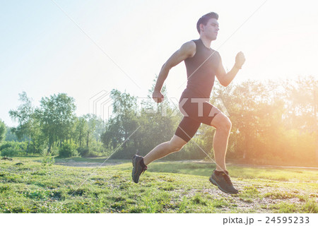 Portrait of fit athletic man jogging on the street Portrait of fit athletic man jogging on the street 24595233