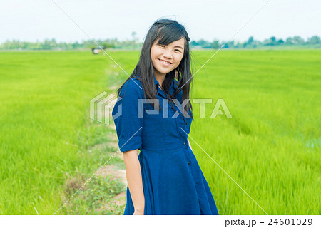 Portrait of asian woman blue dress on rice field Portrait of asian woman blue dress on rice field 24601029