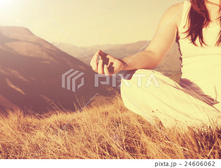 Lady Meditating in Lotus Position on Top of the Mountain Lady Meditating in Lotus Position on Top of the Mountain 24606062