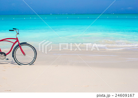 Bike on a tropical beach against the turquoise Bike on a tropical beach against the turquoise 24609167
