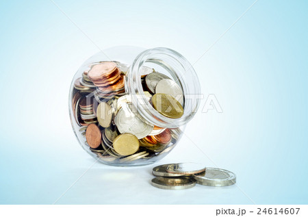 Money in the glass bottle on wooden table. Money in the glass bottle on wooden table. 24614607