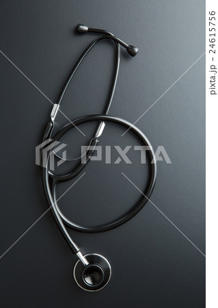 Stethoscope on black table. Stethoscope on black table. 24615756