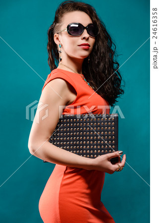 Beautiful girl with a sunglasses and clutch bag 24616358