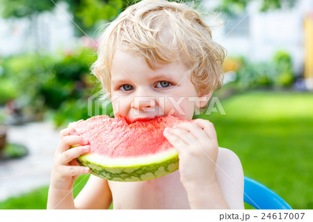 little toddler boy  eating healthy watermelon in 24617007