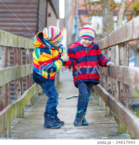 Two little kid boys outdoors in spring town Two little kid boys outdoors in spring town 24617043
