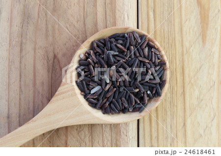 Organic riceberry rice in wooden spoon on wood. Organic riceberry rice in wooden spoon on wood. 24618461