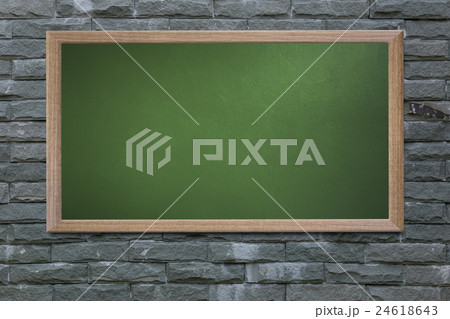 Blank old school blackboard on a grunge wall. 24618643