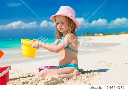 Adorable little girl playing with toys on beach Adorable little girl playing with toys on beach 24624381