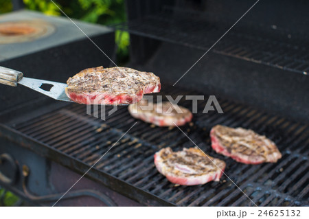 Fresh juicy meat on an open barbecue 24625132