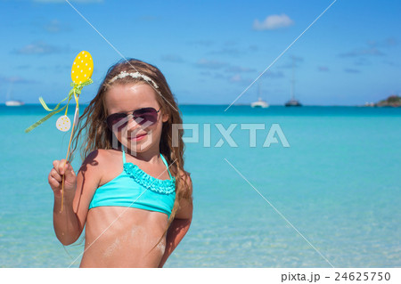 Adorable little girl at white beach during summer 24625750