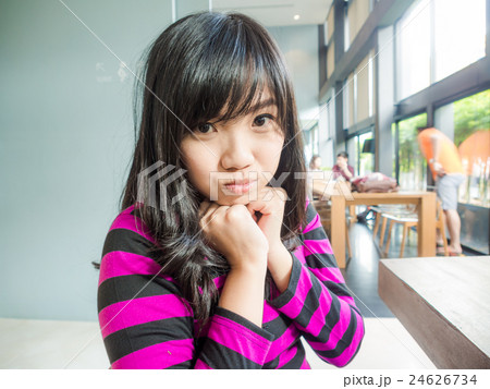 Young smiling asian women sitting in coffee shop 24626734