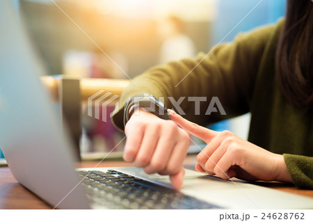 Woman connecting with smart watch and laptop computer 24628762