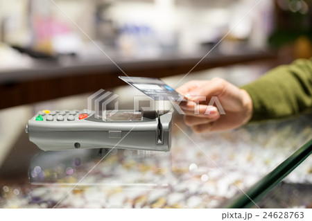 Woman pay by credit card with NFC Woman pay by credit card with NFC 24628763