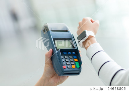 Woman using smart watch to pay by NFC technology 24628806
