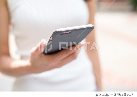 Woman using mobile phone Woman using mobile phone 24628917
