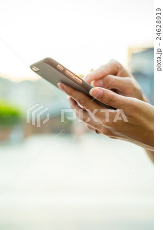 Woman sending sms on mobile phone Woman sending sms on mobile phone 24628919