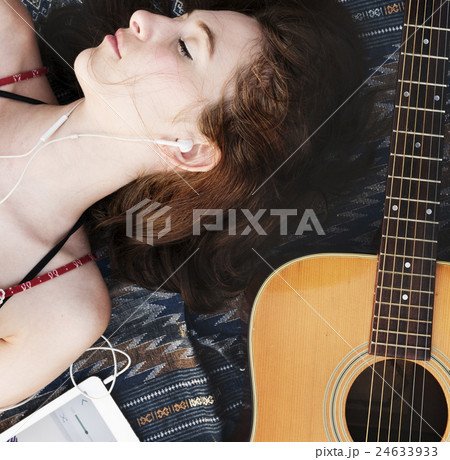Girl Guitar Earphones Digital Device Lie Down Concept 24633933