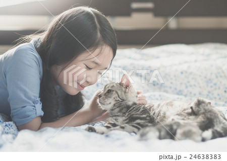asian girl playing with american short hair cat 24638383
