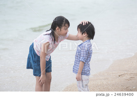 Asian girl is comforting her crying brother Asian girl is comforting her crying brother 24639400