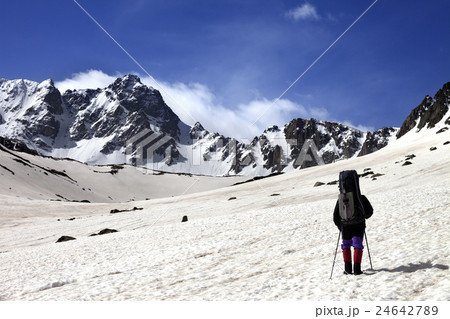 Hiker on snow plateau at spring mountain. Hiker on snow plateau at spring mountain. 24642789