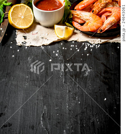 Shrimp with tomato sauce on the old fabric. 24643061