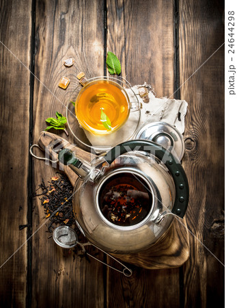 Kettle with fragrant floral tea. Kettle with fragrant floral tea. 24644298