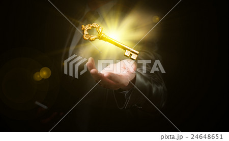 businessman hold a gold shining key 24648651
