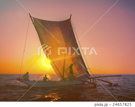 Fishermen on a Catamaran at Sunset Concept Fishermen on a Catamaran at Sunset Concept 24657825