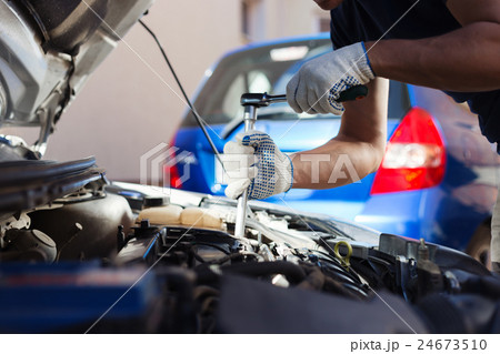 Mechanic working in auto repair garage. Car 24673510