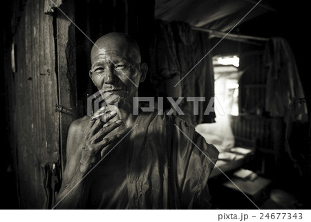 Smoking Cambodian Monk Portrait Concept Smoking Cambodian Monk Portrait Concept 24677343