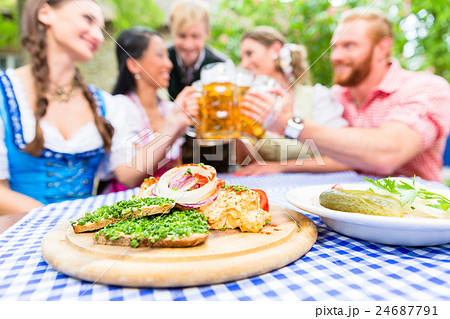 Friends in beer garden with drink and appetizers 24687791
