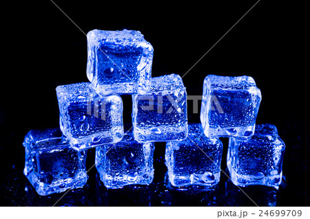 ice cubes in blue light on a black table. ice cubes in blue light on a black table. 24699709