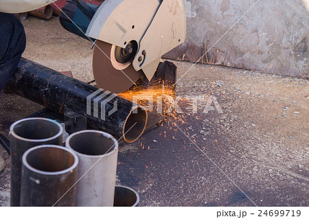 electric saw and hands of worker with sparks. 24699719