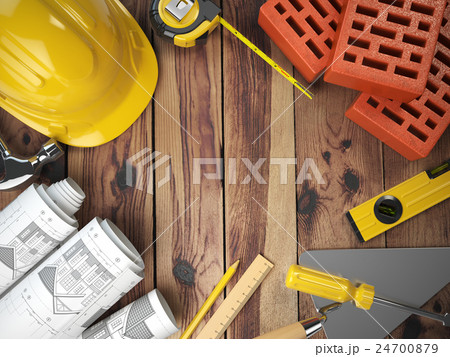 Construction tools on a wooden background.  24700879