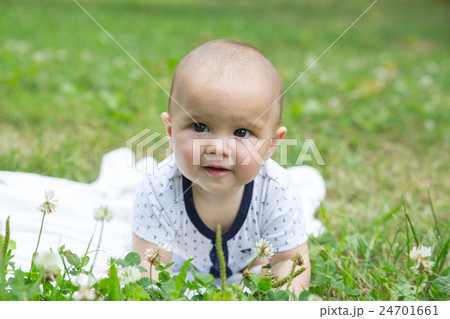 Baby girl crawling on the grass. Selective focus Baby girl crawling on the grass. Selective focus 24701661
