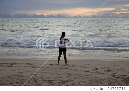 Thai girl doing gymnastics on the beach Thai girl doing gymnastics on the beach 24705731